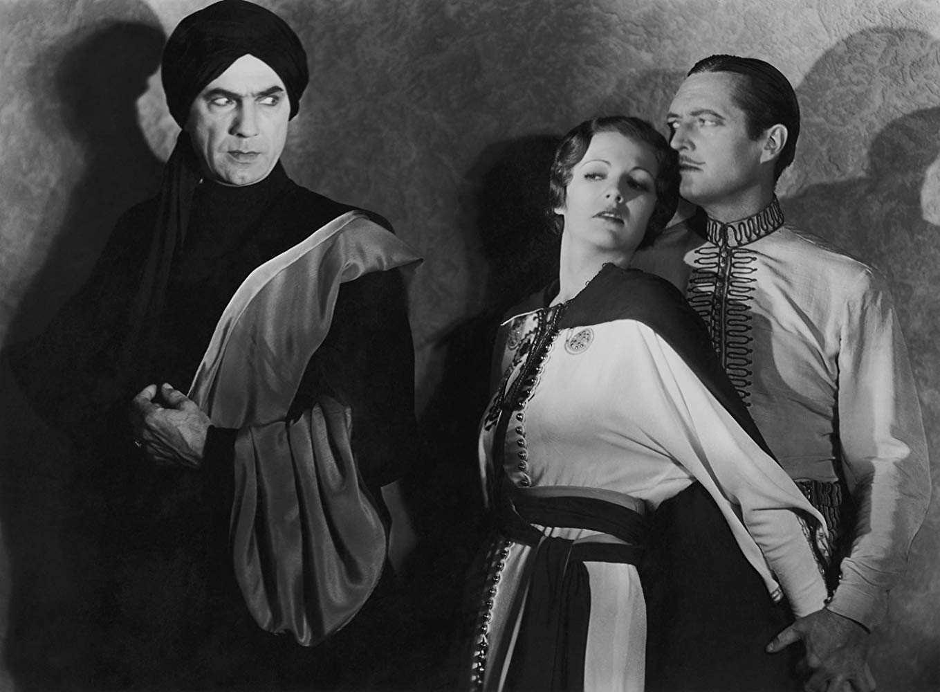 Chandu (Edmund Lowe) guards Princes Nadji (Irene Ware) from the evil Roxor (Bela Lugosi) in Chandu the Magician (1932)