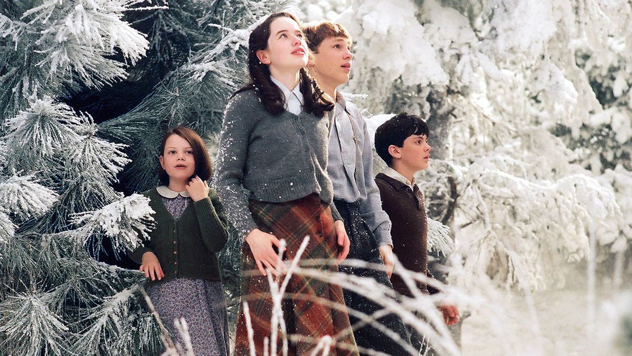 The Pevensie children emerge through the wardrobe into Narnia - (l to r) Lucy (Georgie Henley), Susan (Anna Popplewell), Peter (William Moseley) and Edmund (Skandar Keynes) in The Chronicles of Narnia: The Lion, The Witch and the Wardrobe (2005)