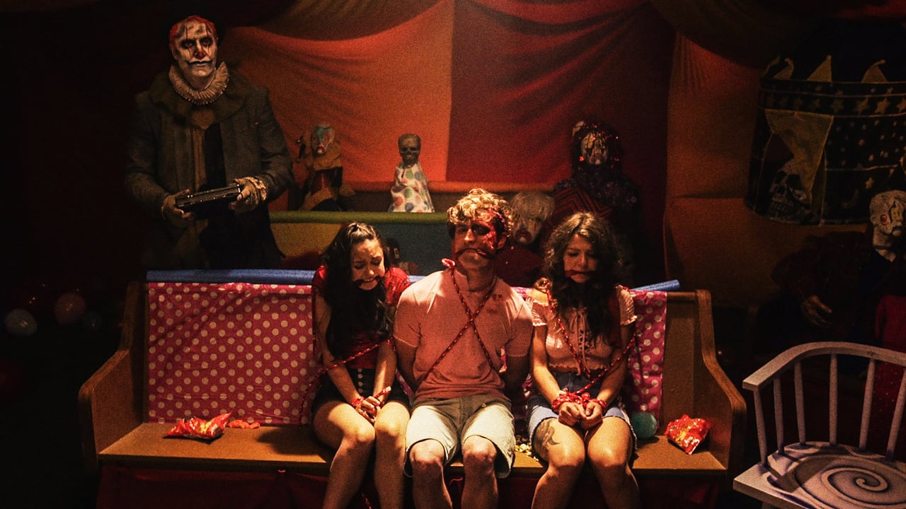 Thoth the Clown (Dave Klec) with an imprisoned Sally (Audrey Gibbs), Austin (Adam Elshar) and Sarah (Micavrie Amaia) in Clown (2019)