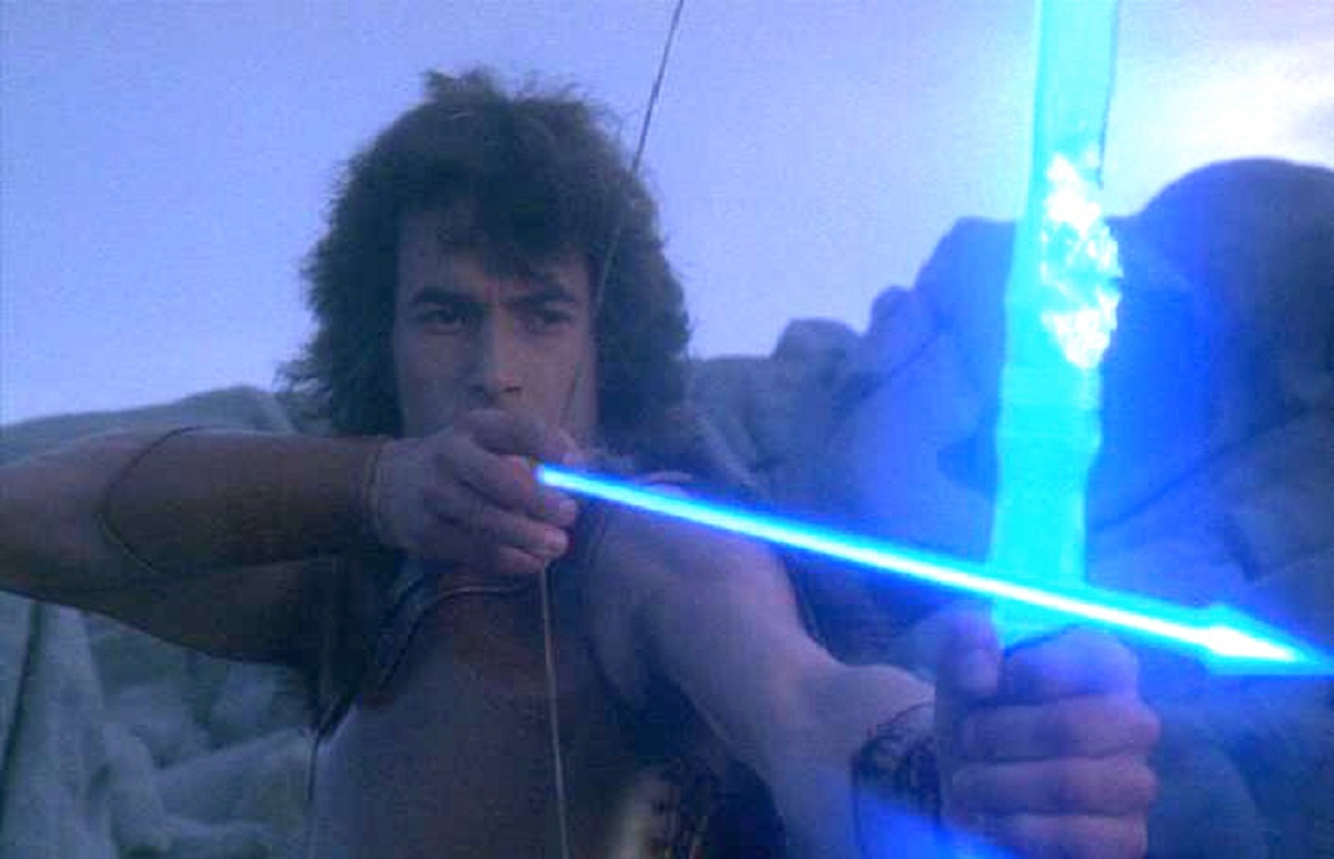 Ilias (Andrea Occhipinti) fires a laser arrow in Conquest (1983)