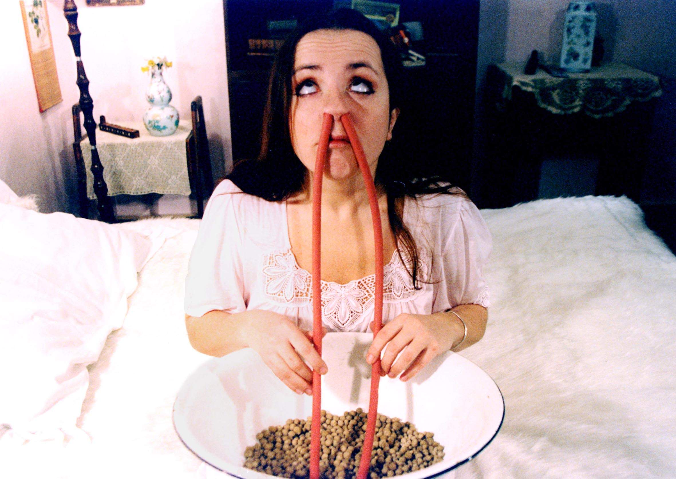 Barbora Hrzanova develops an unusual fetish for inhaling balls of bread up her nose in Conspirators of Pleasure (1996)