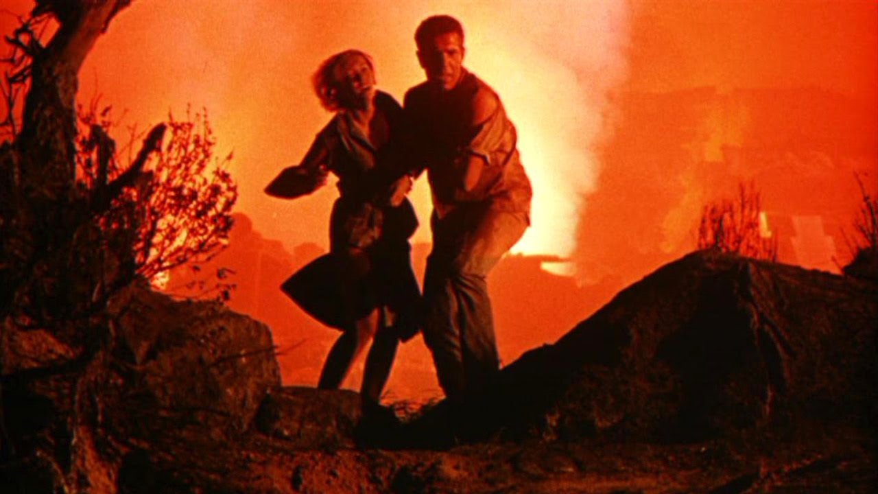 Janette Scott and Kieron Moore flee lava eruptions in Crack in the World (1965)
