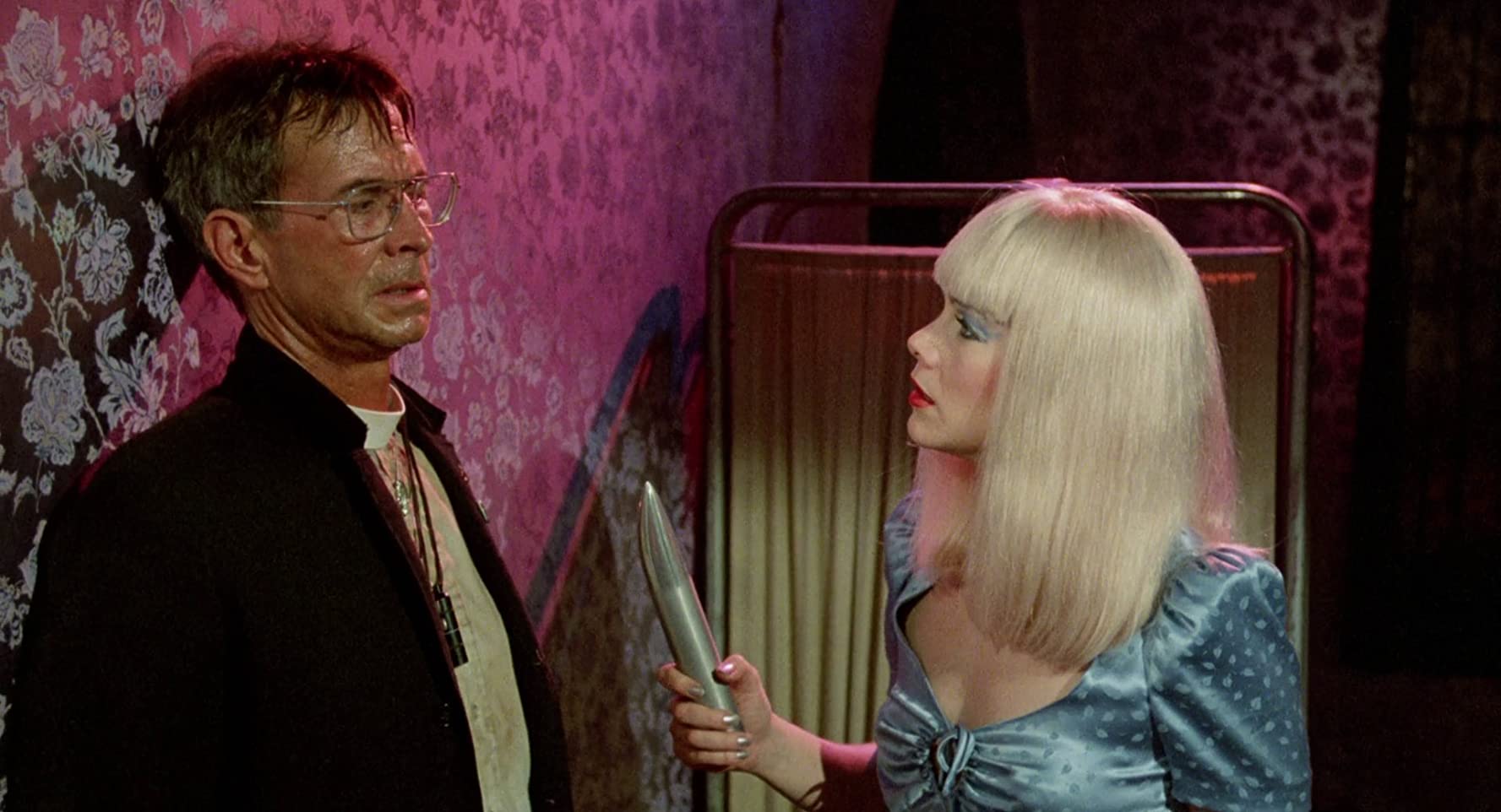 China Blue (Kathleen Turner) confronts priest Anthony Perkins in Crimes of Passion (1984)