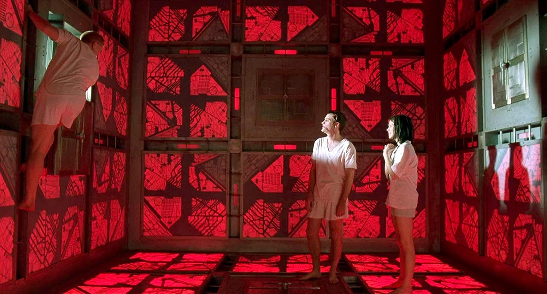 A labyrinth of identical rooms - (l to r) Andrew Miller, David Hewlett and Nicole de Boer in Cube (1997)