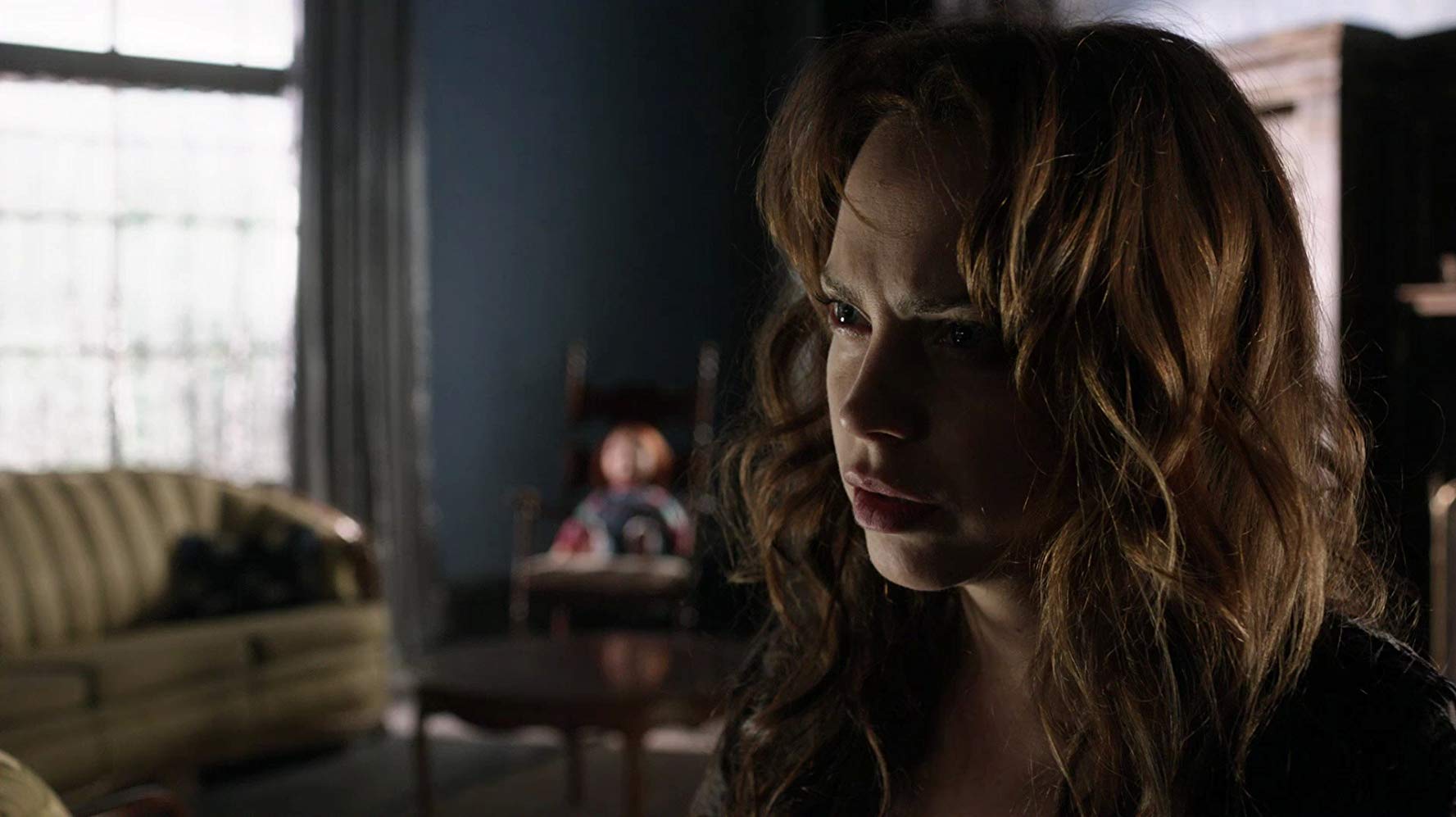 Brad Dourif's daughter Fiona with Chucky in the background in Curse of Chucky (2013)