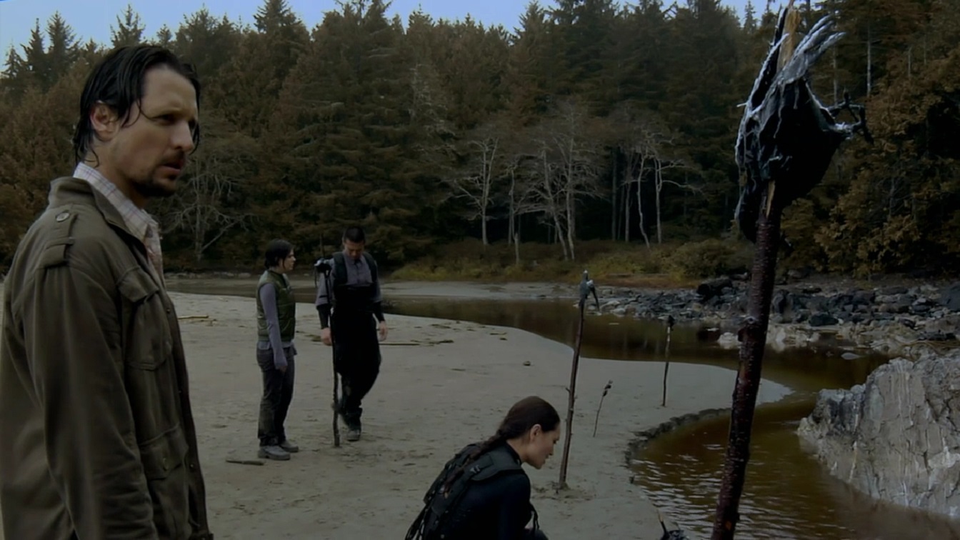 The investigators on the island ponder the significance of the dead crows in Dark Island (2010)