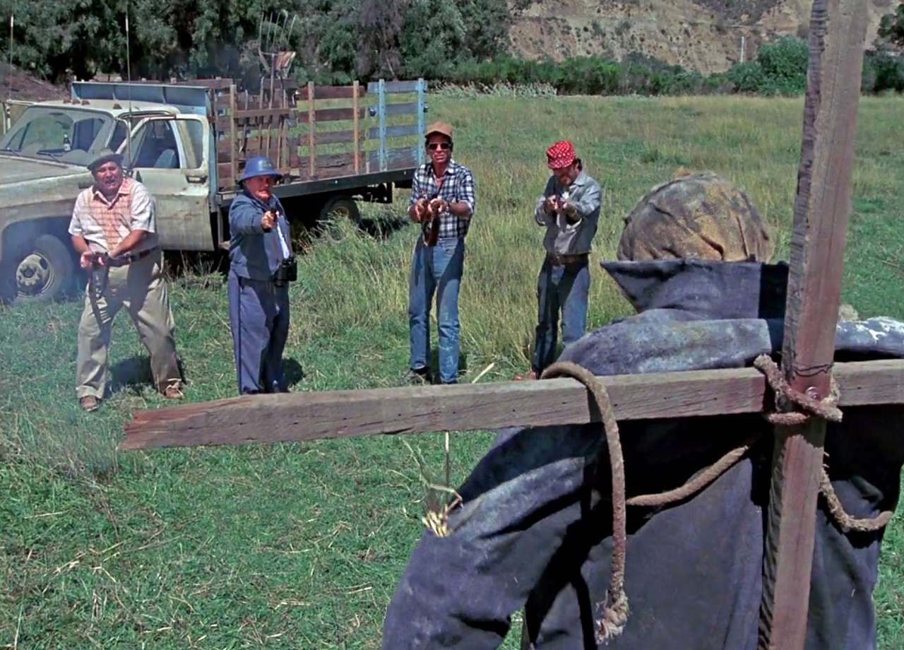 The lynch mob (l to r) Claude Earl Jones, Charles Durning, Lane Smith and Robert F. Lyons murder Larry Drake disguised as a scarecrow in Dark Night of the Scarecrow (1981)