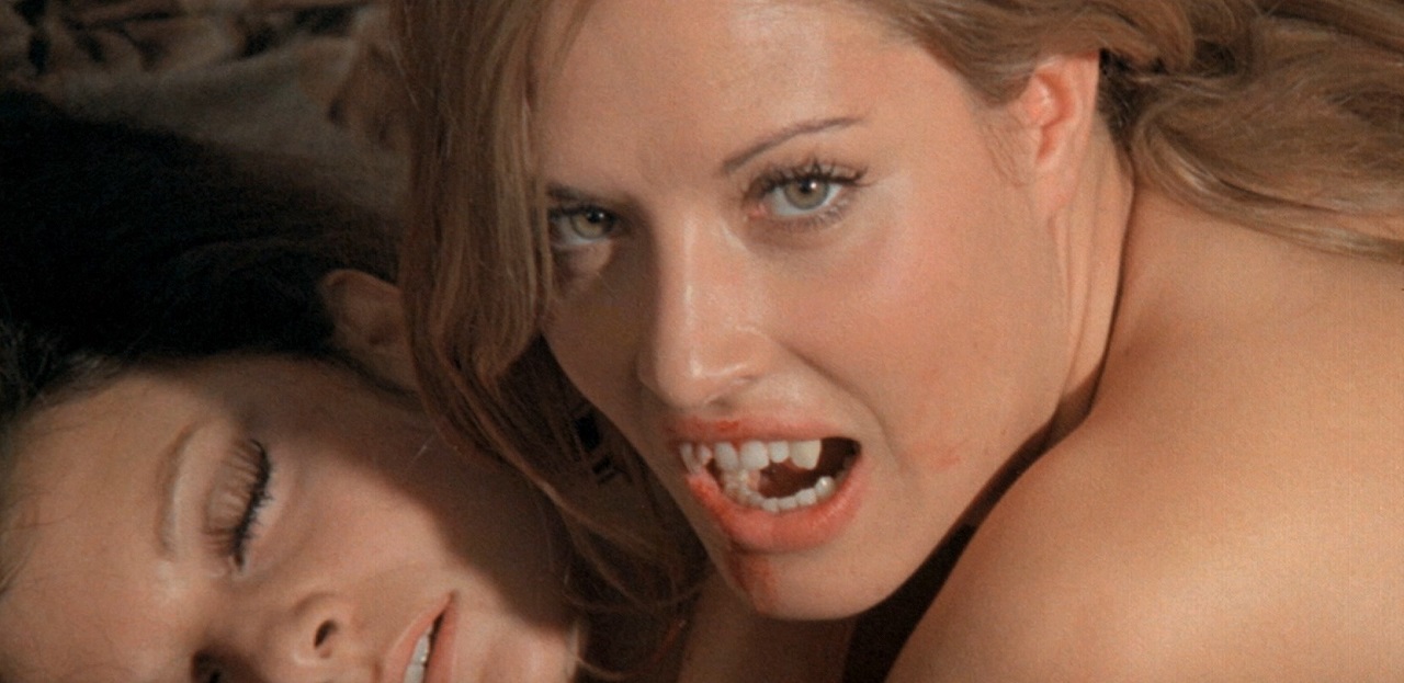 Britt Nichols feasts on the neck of Anne Libert in The Daughter of Dracula (1972)