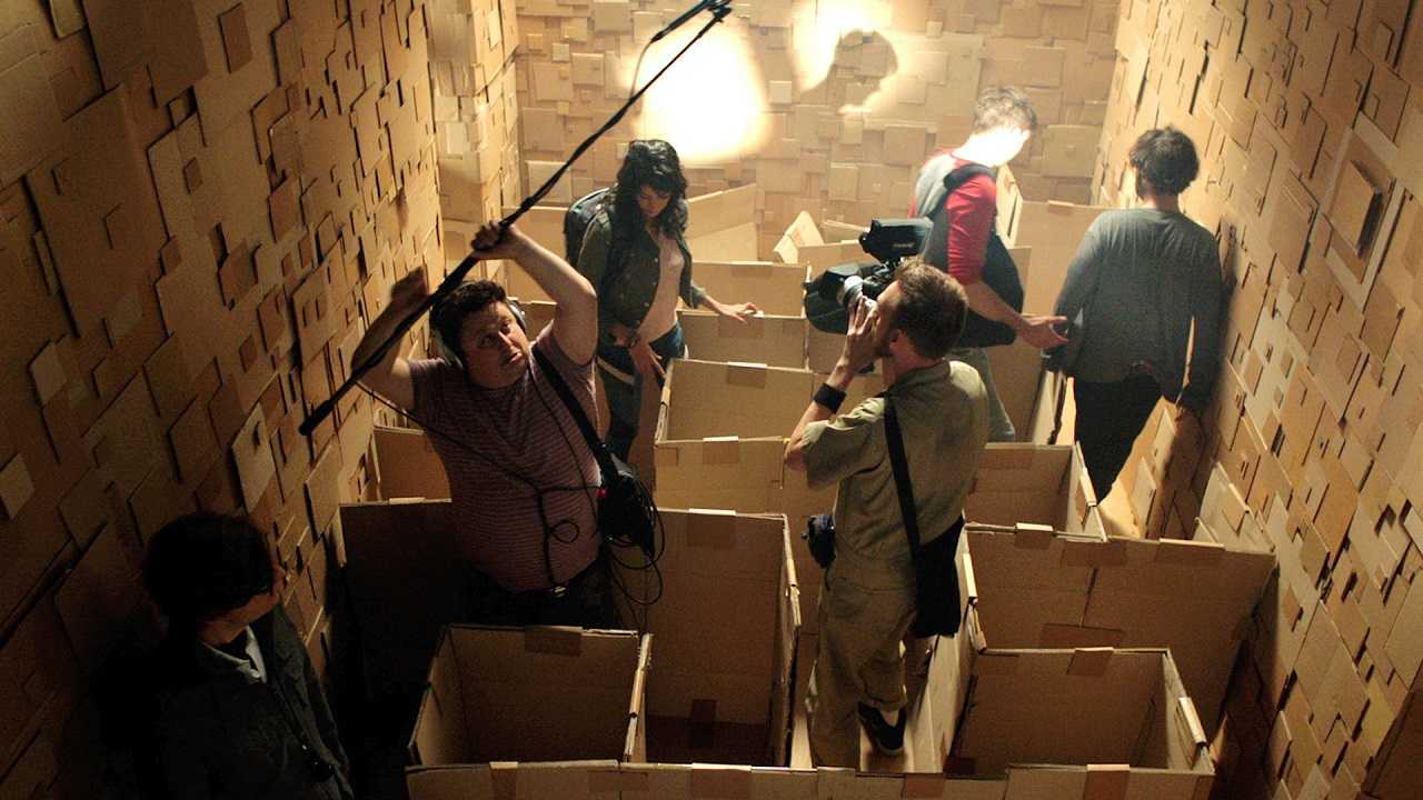 The film crew navigate the inside of the cardboard maze in Dave Made a Maze (2017)