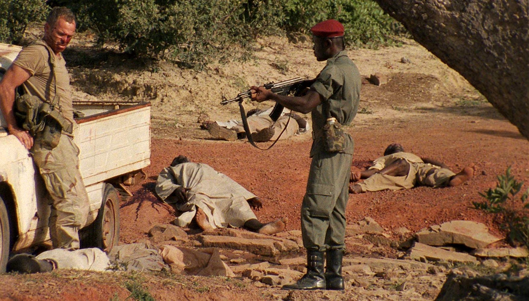 Tenuous truce between (l to r) Westerner Rob Freeman and local soldier Prince David Osei in The Dead (2010)