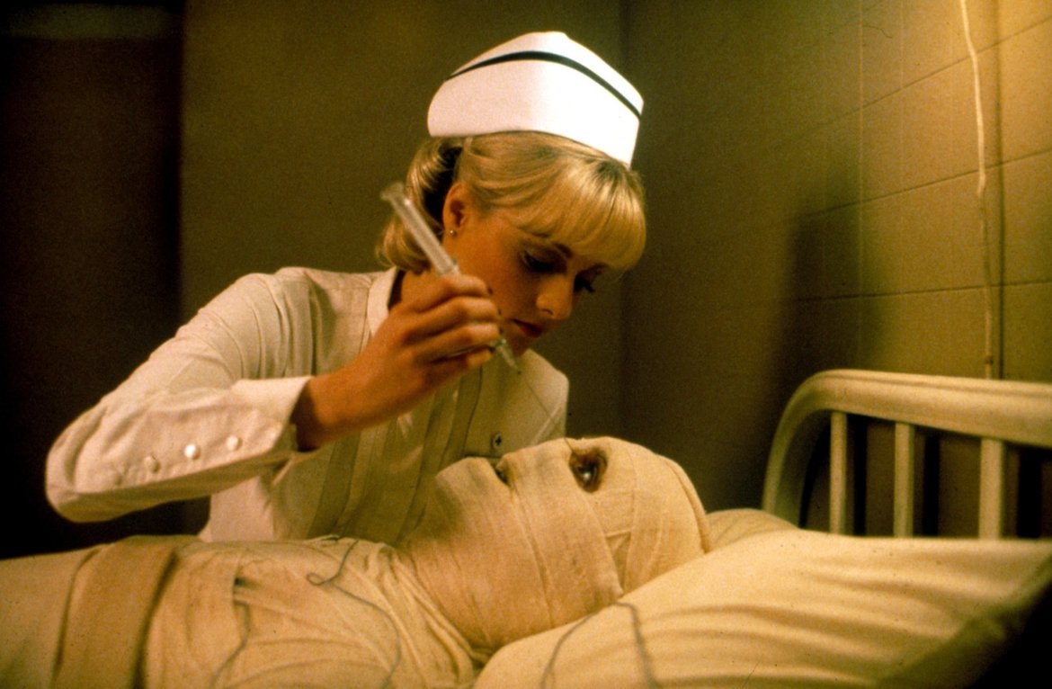 Nurse Lisa Blount administers medication to a patient in Dead and Buried (1981)