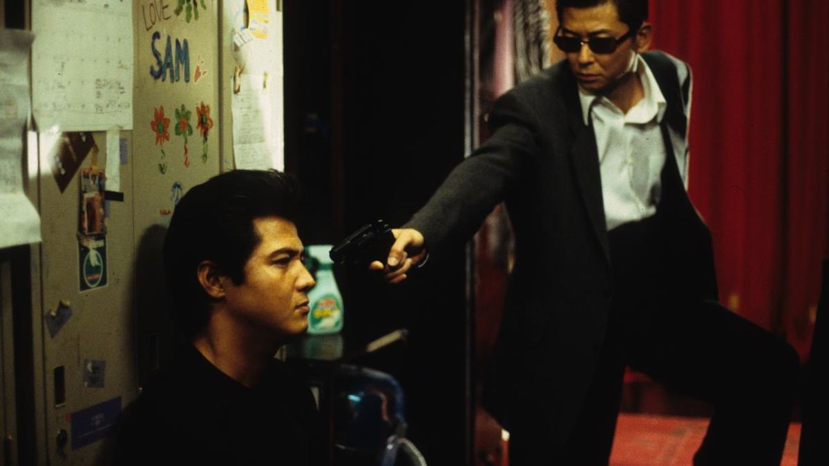 (l to r) Yakuza Riki Takeuchi has a gun held on him by detective Sho Aikawa in Dead or Alive (1999)