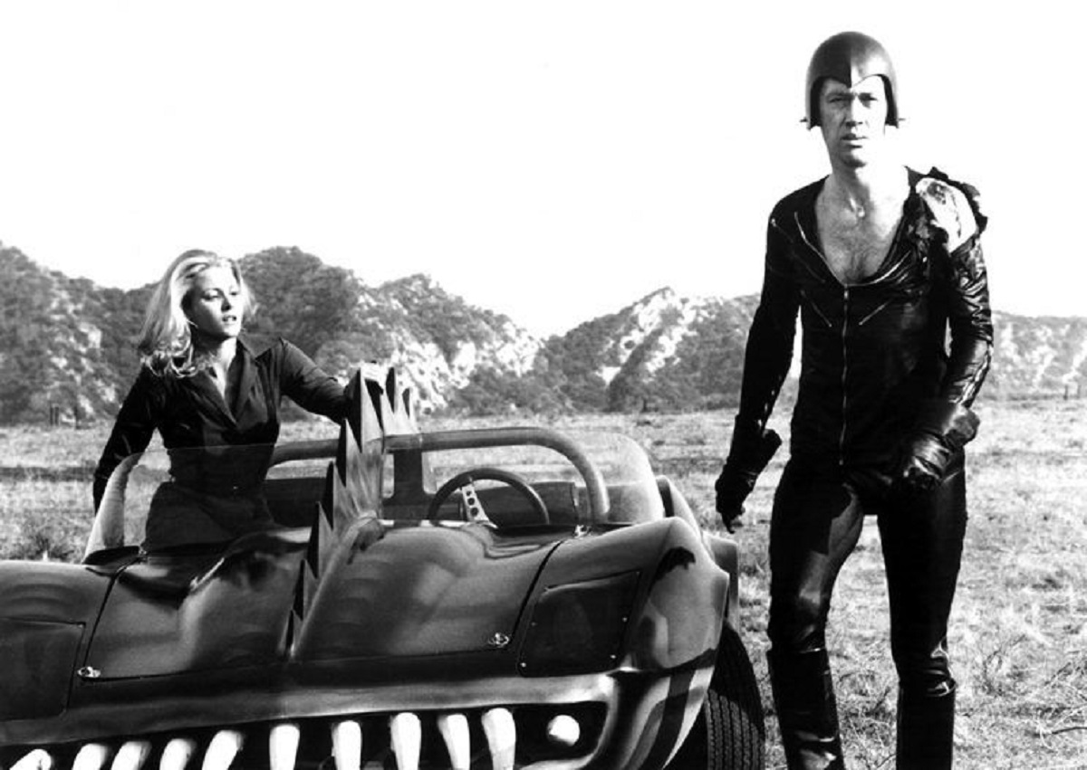 Frankenstein (David Carradine) with his co-driver Simone Griffeth in Death Race 2000 (1975)