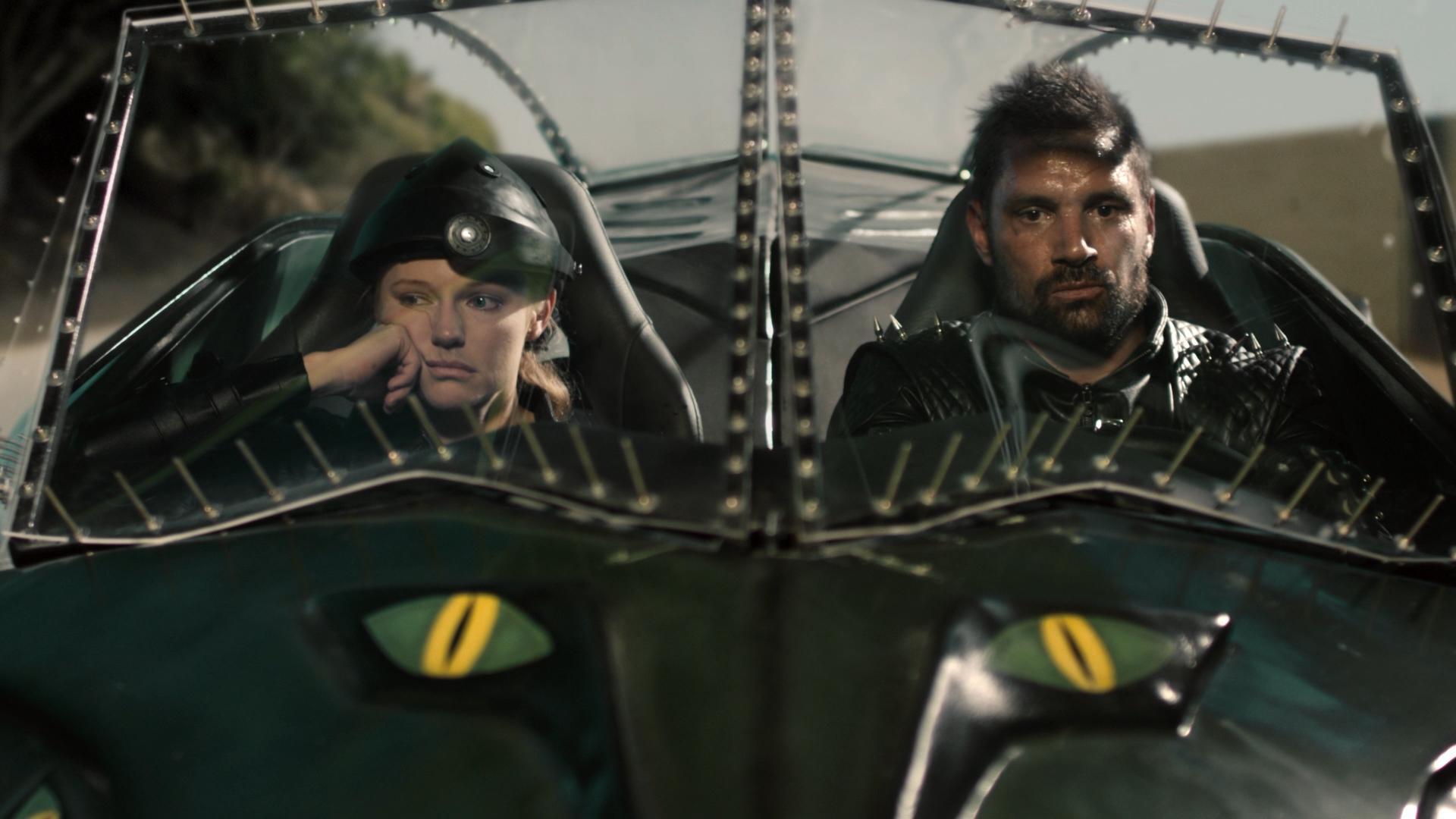 Frankenstein (Manu Bennett) and his passenger Annie Sullivan (Marci Miller) in Death Race 2050 (2017)