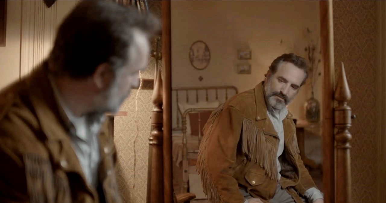 Jean Dujardin admires his deerskin coat in Deerskin (2019)