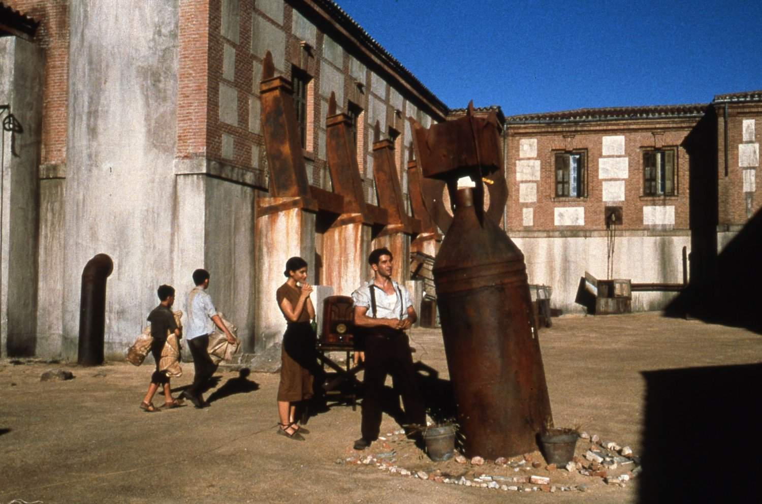 The unexploded bomb in the courtyard with Irene Visado and Eduardo Noriega standing next to it in The Devil's Backbone (2001)