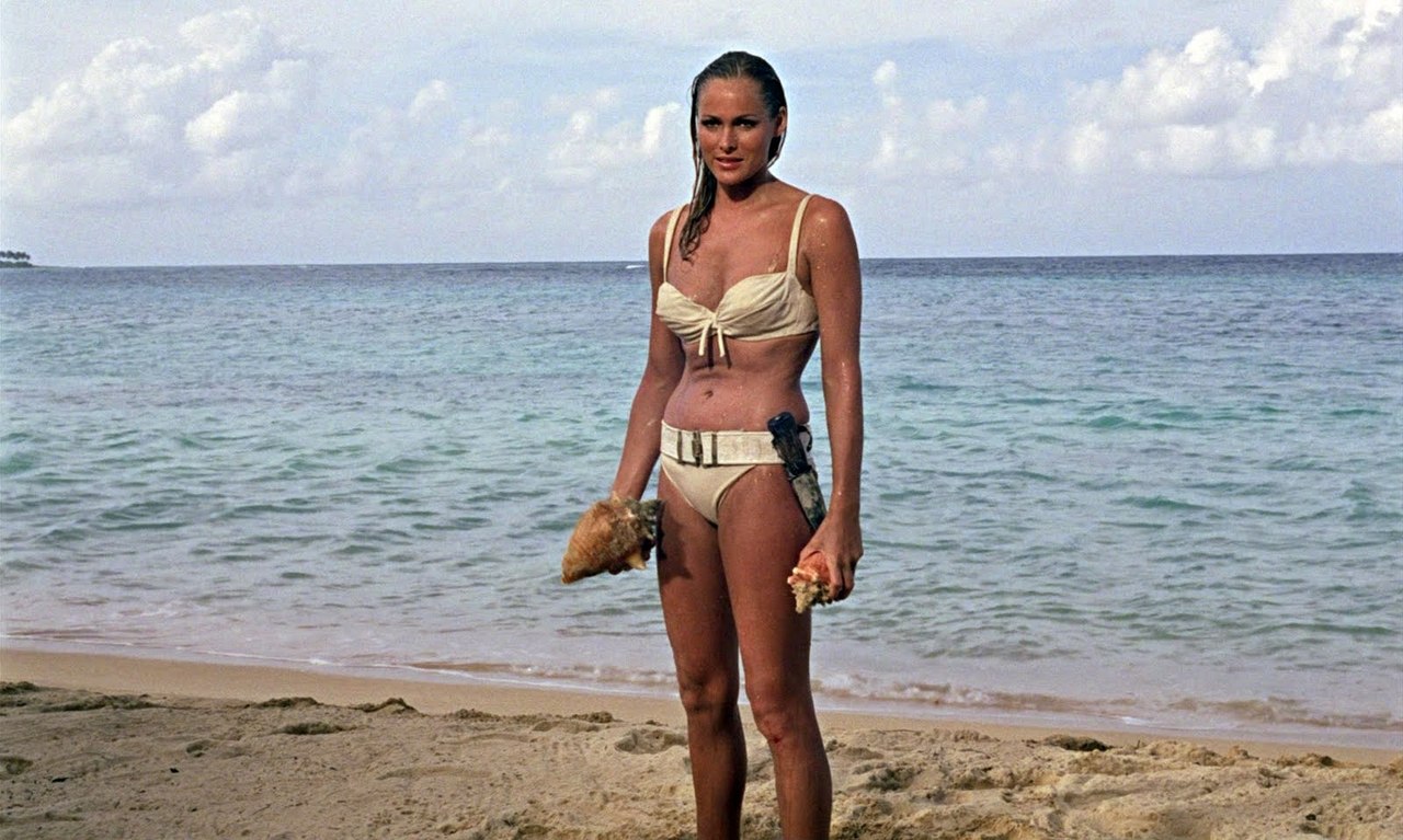 The first of the Bond girls - Ursula Andress as Honeychile Rider in her iconic entrance from out of the sea in a bikini in Dr No (1962)