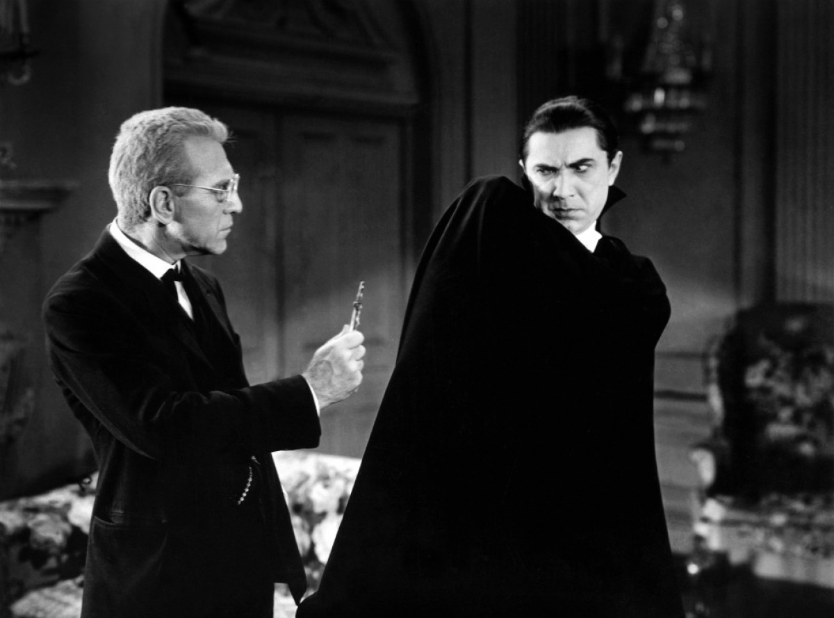 Van Sloan) wields crucifix at Dracula (Bela Lugosi)