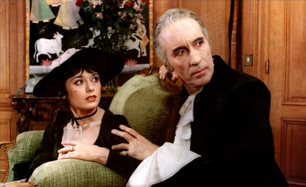 Dracula (Christopher Lee) interrupted in his dealings with Marie-Helene Breillat in Dracula Father and Son (1976)