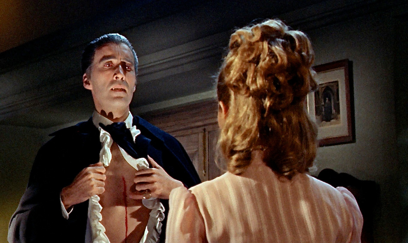 Dracula (Christopher Lee) opens a cut on his chest for Suzan Farmer to drink his blood in Dracula - Prince of Darkness (1966)