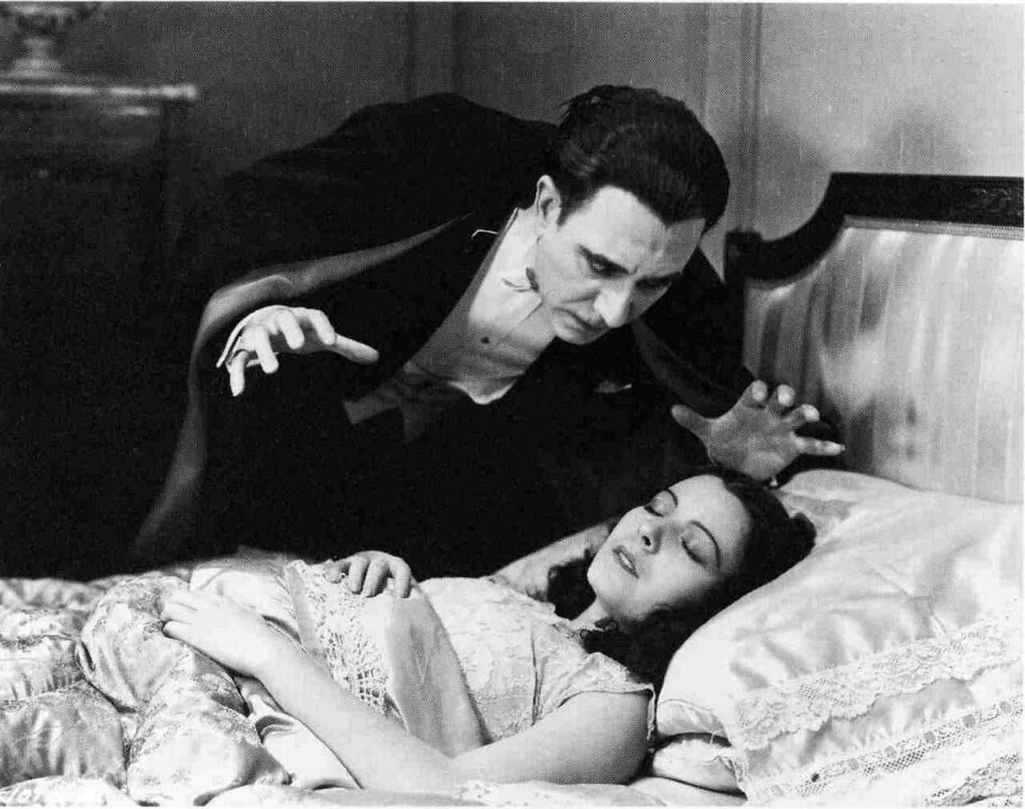 Dracula (Carlos Villarias) prepares to feast on Eva Seward (Lupita Tovar) in Dracula (1931)