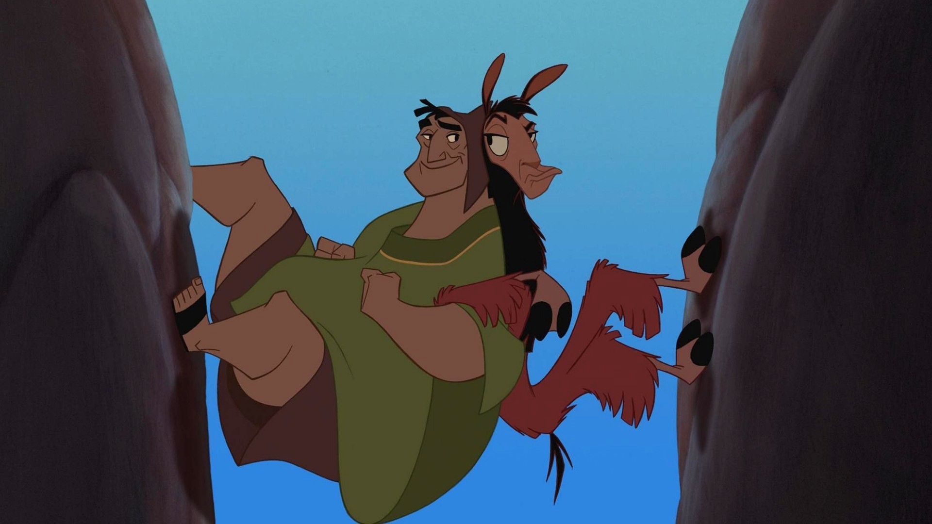 (l to r) Pacha (voiced by John Goodman) and the emperor Kuzco transformed into a llama (voiced by David Spade) try to climb a cliff in The Emperor's New Groove (2000)