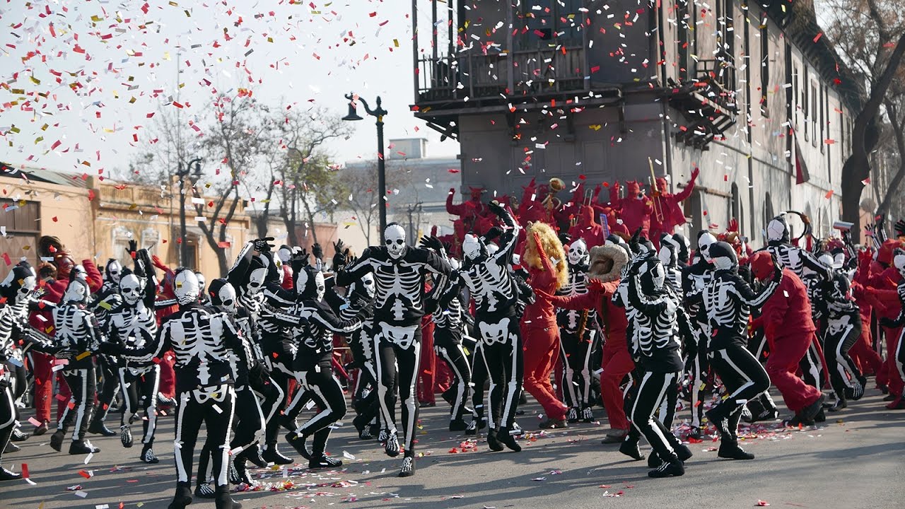Crowds of dancing skeletons and red devils in Endless Poetry (2013)