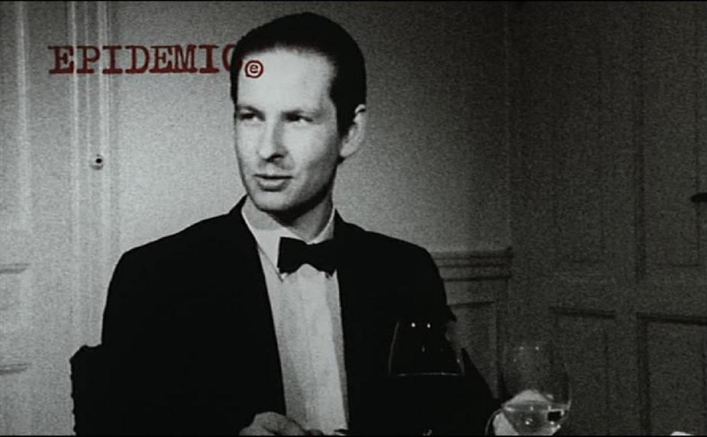 Lars von Trier, playing himself, sits down to a dinner party in Epidemic (1987)