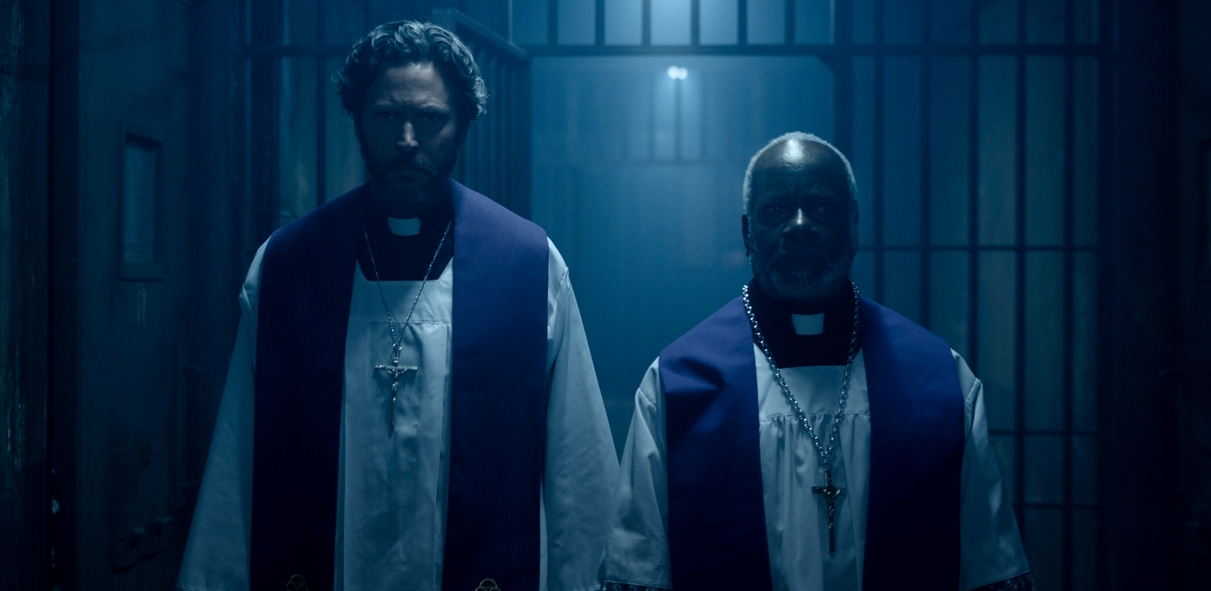 Priests Will Beinbrink and Joseph Marcell go to confront the demon in The Exorcism of God (2021)