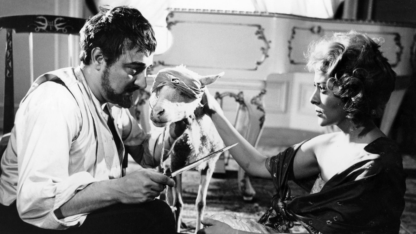 Enrique Rambal menaces Silvia Pinal with a knife in The Exterminating Angel (1962)