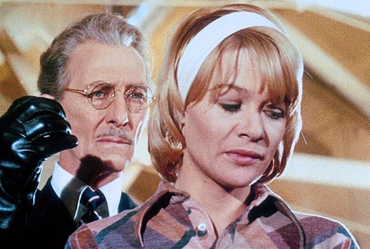 Peter Cushing raises his wooden arm behind Judy Geeson's back in Fear in the Night (1972)