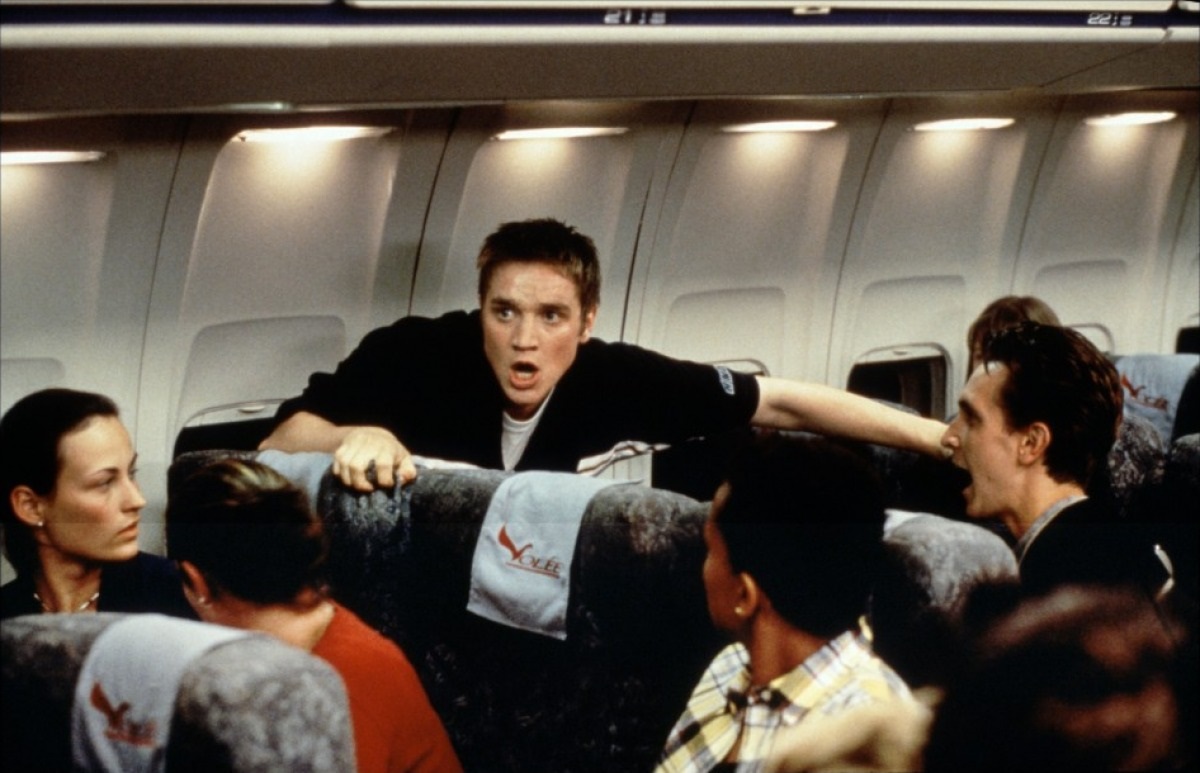 Devon Sawa panics aboard the flight after having a vision of the plane crashing in Final Destination (2000)