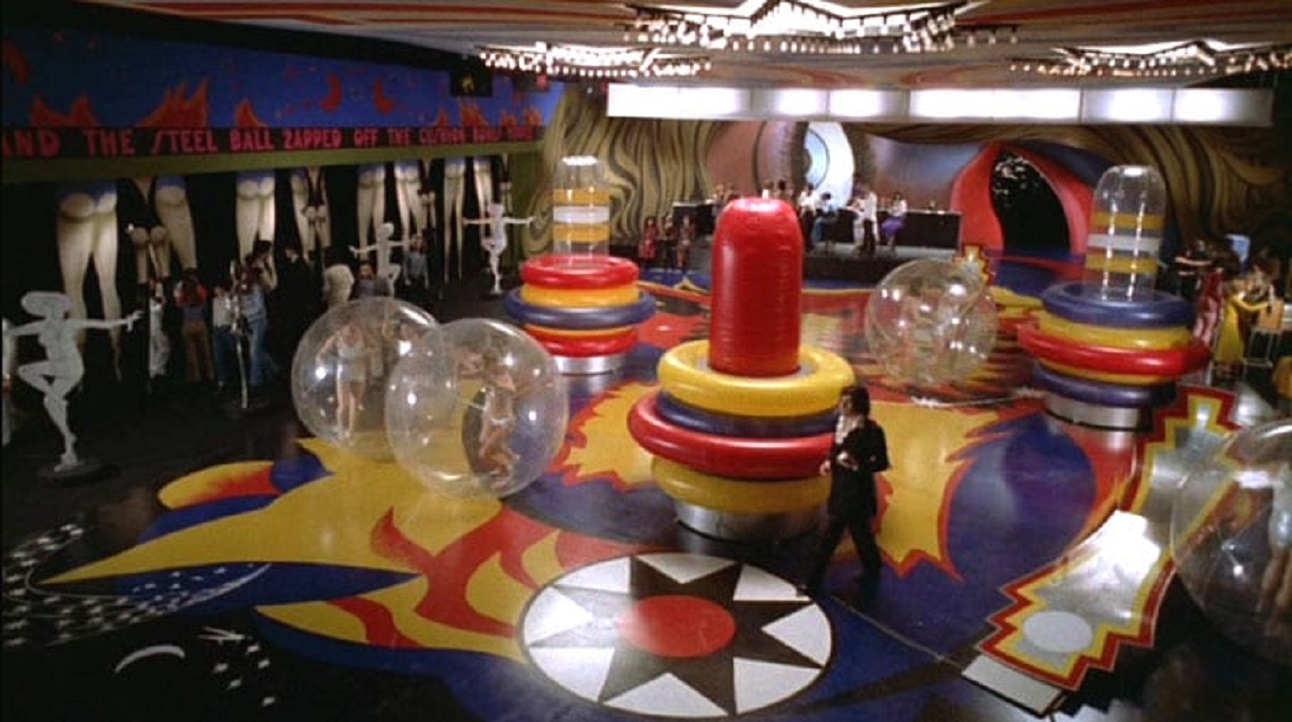 Jerry Cornelius (Jon Finch) strides through the set built like giant pinball in The Final Programme (1974) - an example of the film's imaginative production design