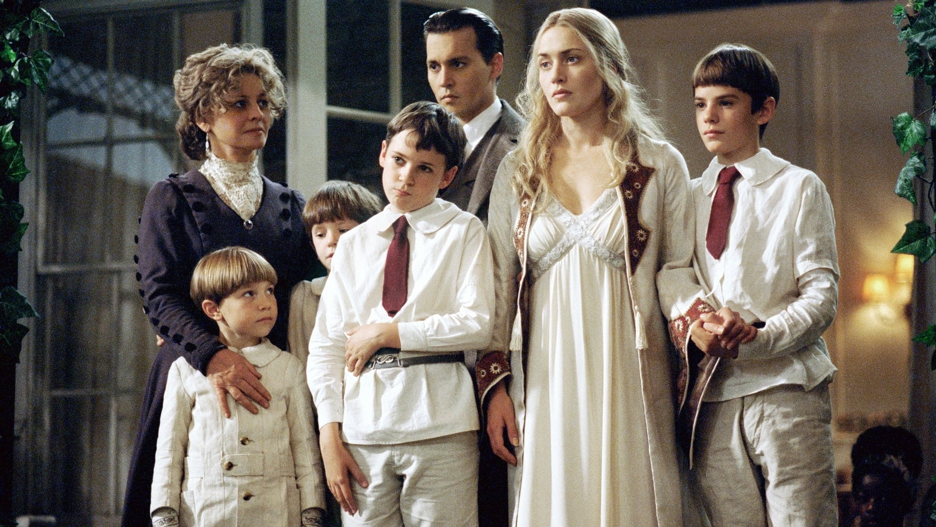 Johnny Depp and Kate Winslet surrounded by the Llewellyn Davies children with Julie Christie in Finding Neverland (2004)