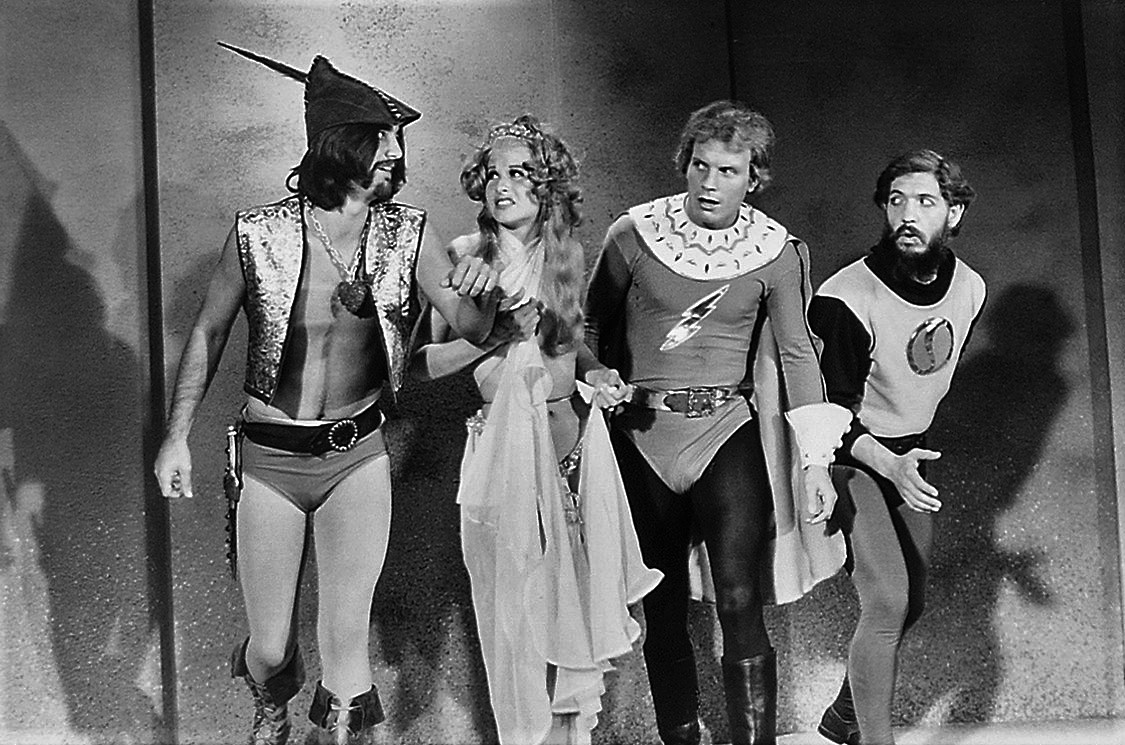 (l to r) Prince Precious (Lance Larsen), Dale Ardor (Suzanne Field), Flesh Gordon (Jason Williams) and Dr Flexei Jerkoff (Joseph Hudgins) in Flesh Gordon (1974)