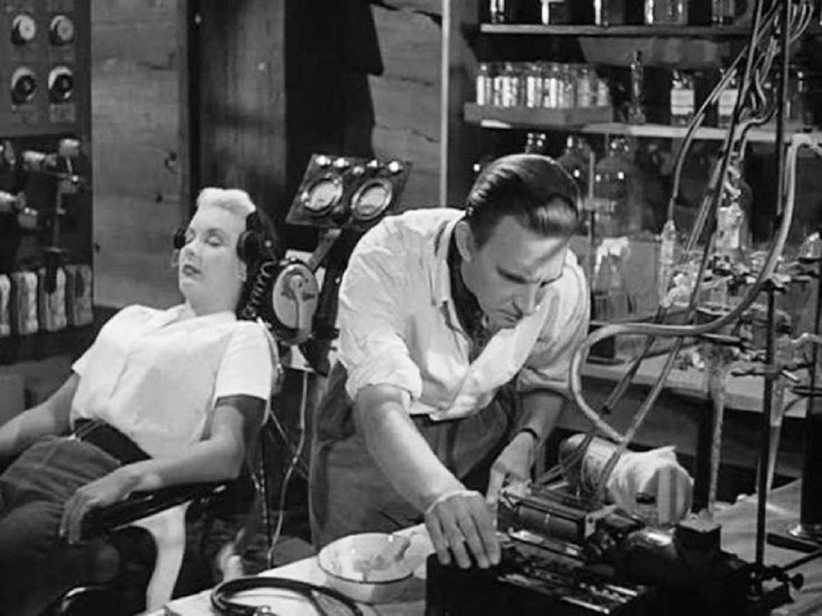 Stephen Murray prepares to make a copy of Barbara Payton in Four Sided Triangle (1953)