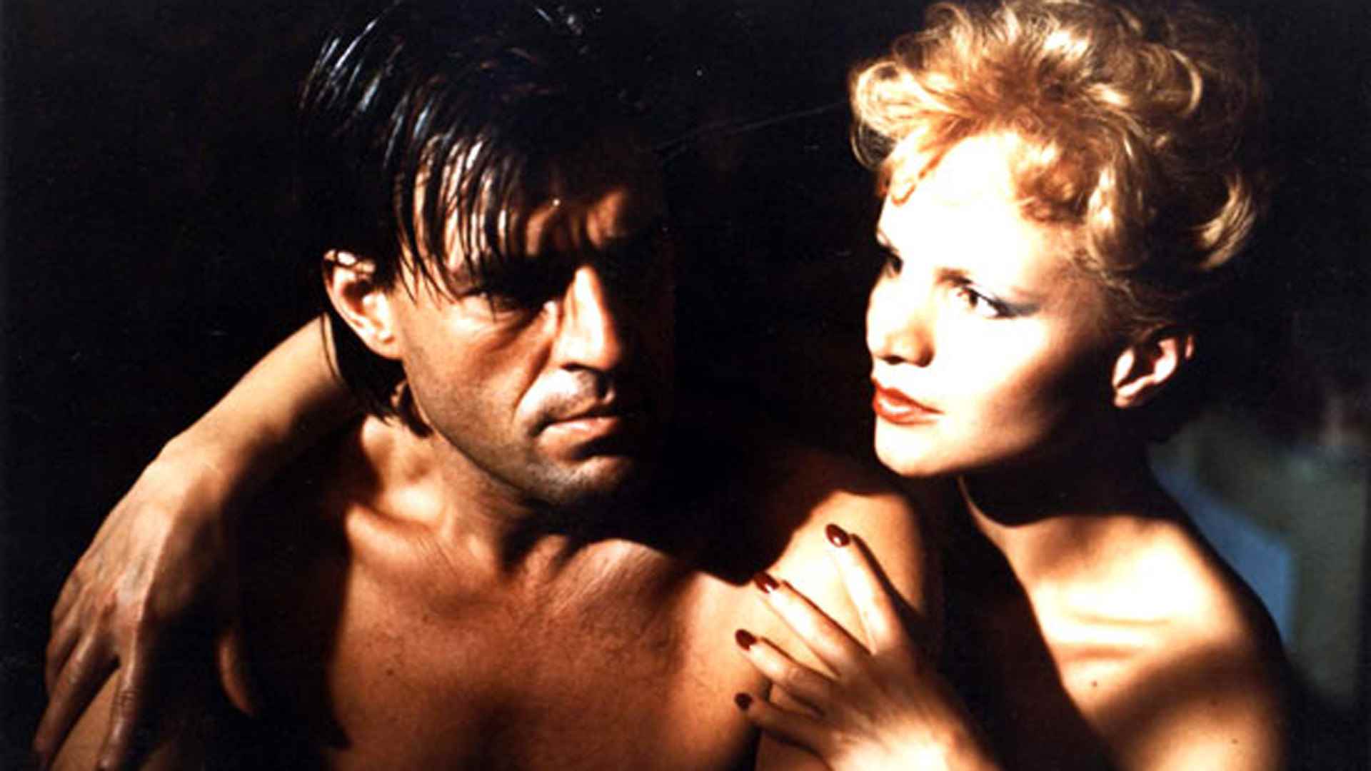 Gay writer Jeroen Krabbe in the arms of femme fatale Renee Soutendijk in The Fourth Man (1983)