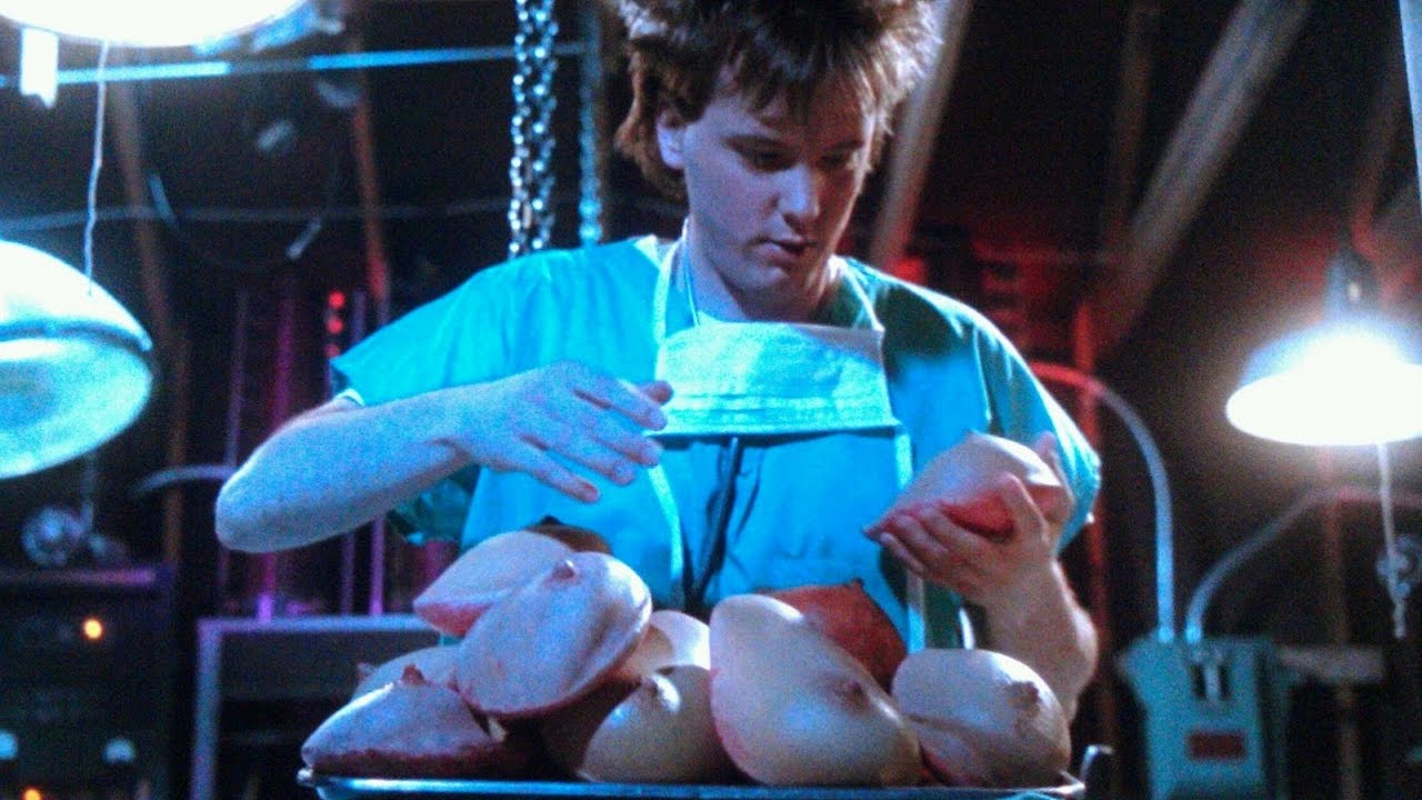 Jeffrey Franken (James Lorinz) examines a selection of breasts in Frankenhooker (1990)
