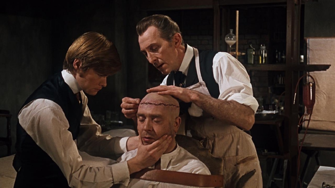 Frankenstein (Peter Cushing) (r) assisted by Simon Ward (l) prepares to operate on Freddie Jones (c) in Frankenstein Must Be Destroyed (1969)