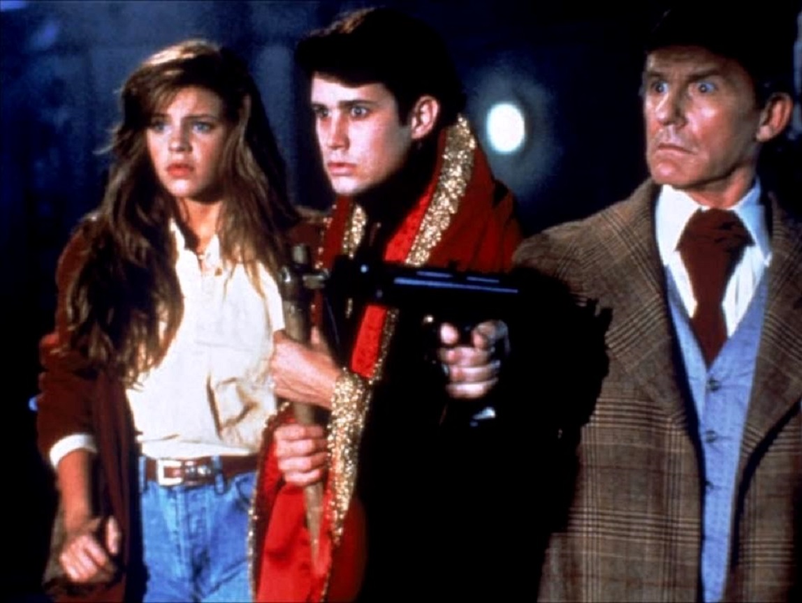 Peter Vincent (Roddy McDowall), Charlie Brewster (William Rgsdale), and new girlfriend Traci Lind in Fright Night Part 2 (1989)