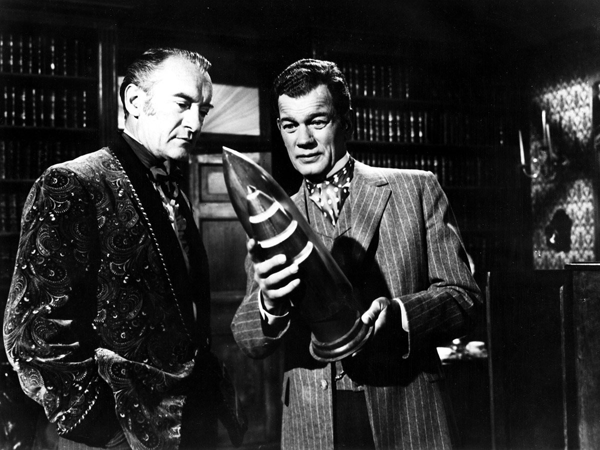 (l to r) Rivals Stuyvesant Nicholl (George Sanders) and Victor Barbicane (Joseph Cotten) plan to launch a rocket in From the Earth to the Moon (1958)