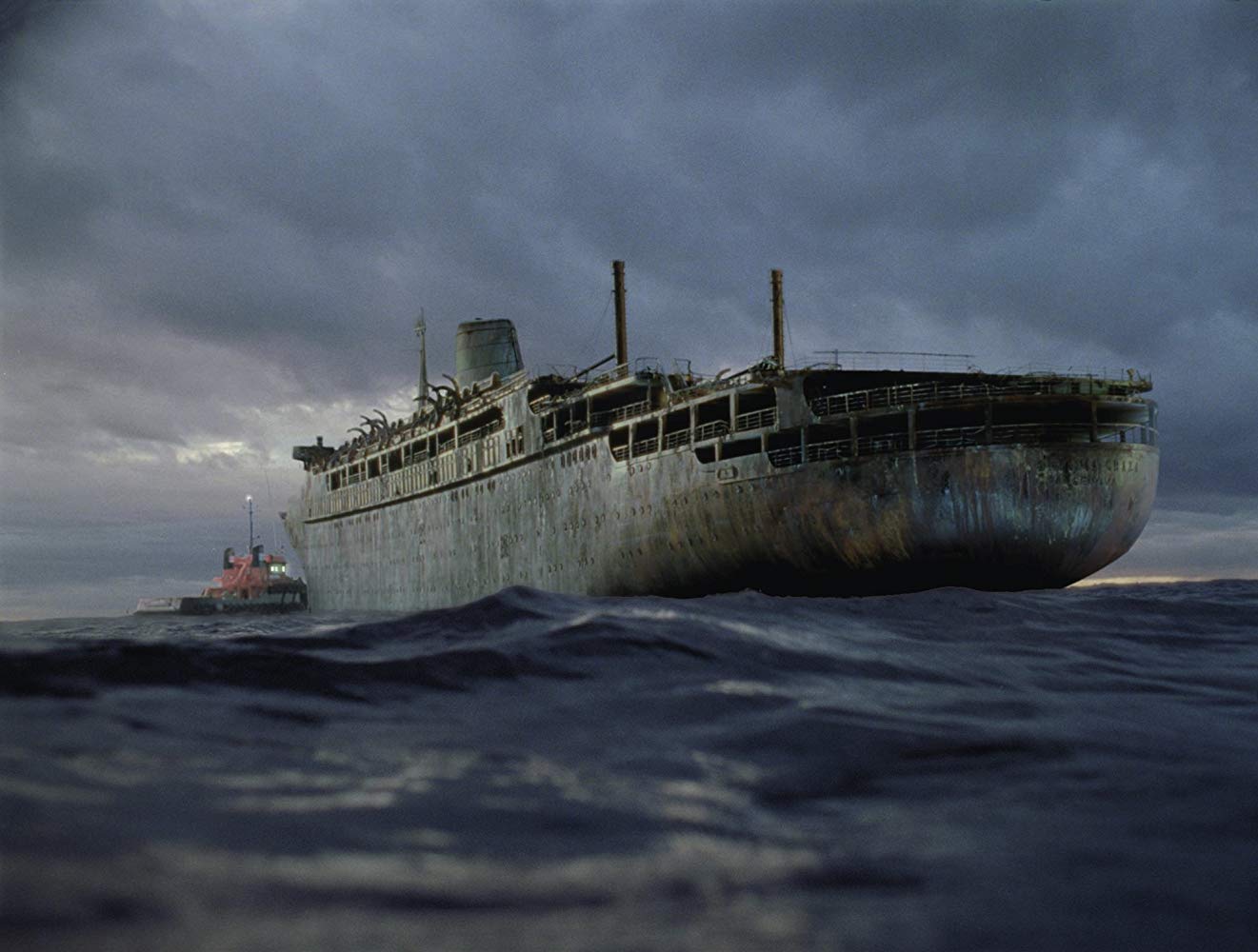 The tug Arctic Warrior approaches the ghost cruise liner Antonia Graza in Ghost Ship (2002)