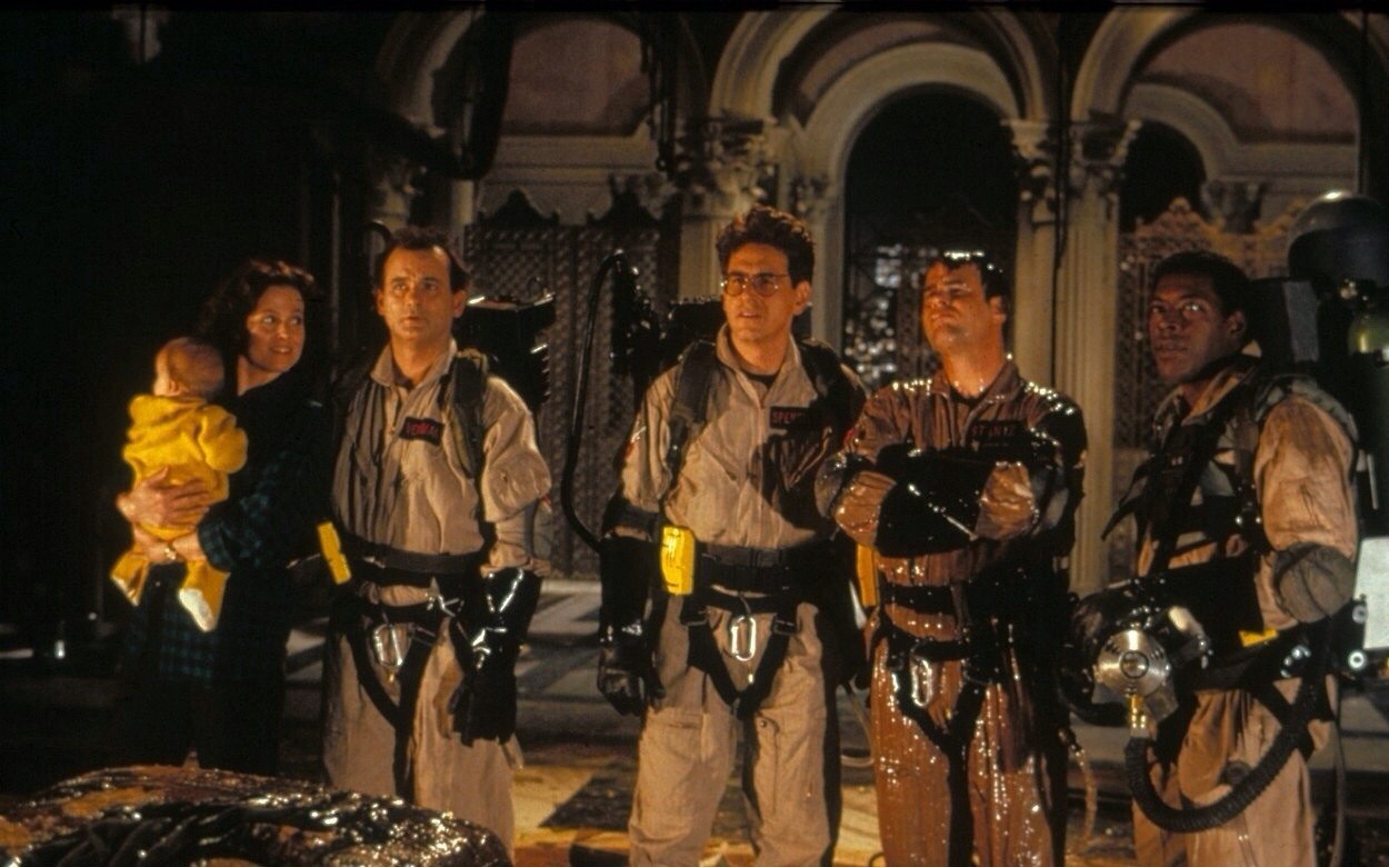 The Ghostbusters back in action - (l to r) Sigourney Weaver (with baby), Bill Murray, Harold Ramis, Dan Aykroyd and Ernie Hudson in Ghostbusters II (1989)