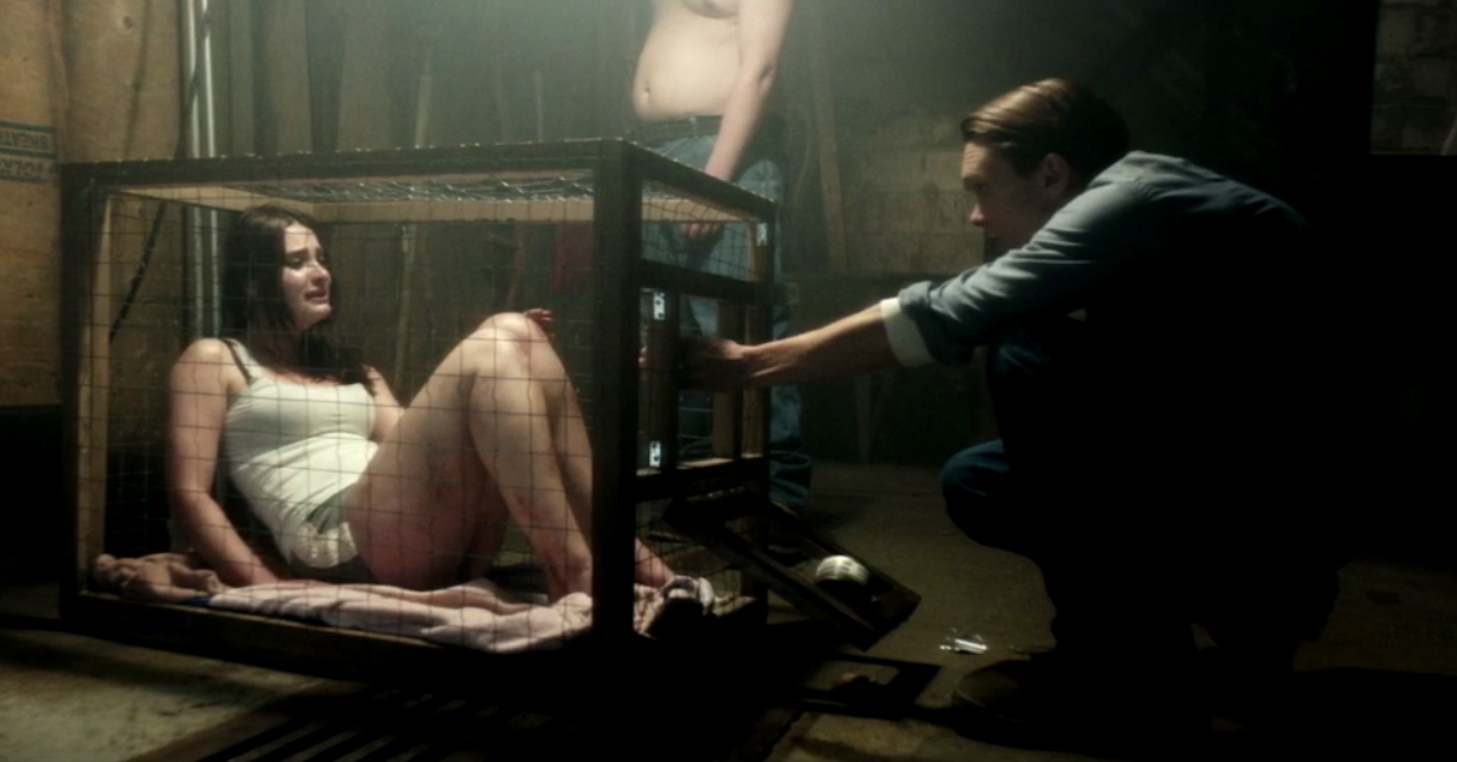 Serial killer Luke Baines with imprisoned victim Eva Bourne in The Girl in the Photographs (2015)