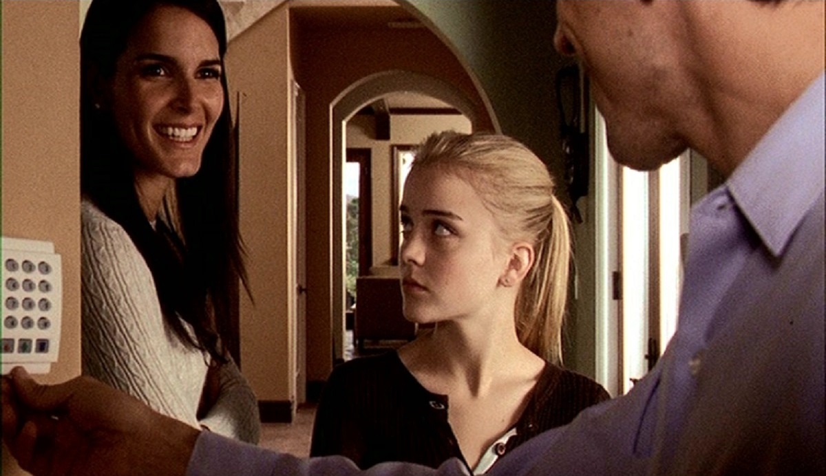 Jordan Hinson (c) with evil step-parents Angie Harmon, (l) and Joel Gretsch (r) in Glass House: The Good Mother (2006)