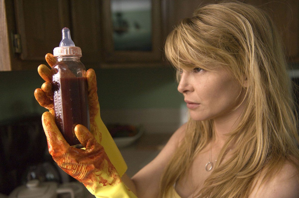 Jordan Ladd prepares a bottle of blood for her baby in Grace (2009)