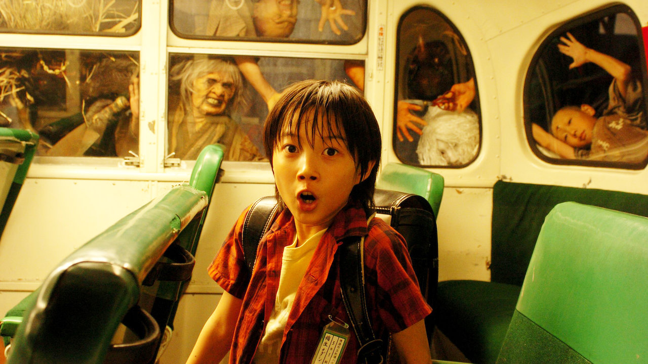 Young Tadashi (Ryuunosuke Kamiki) surrounded by Yokai creatures in The Great Yokai War (2005)