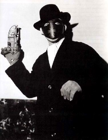 The Green Hornet (Gordon Jones) wields his gas pellet gun in The Green Hornet (1940)