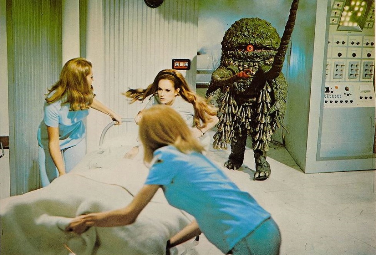 The alien invades the space station as the medical staf flee. With Luciana Paluzzi (c) in The Green Slime (1968)