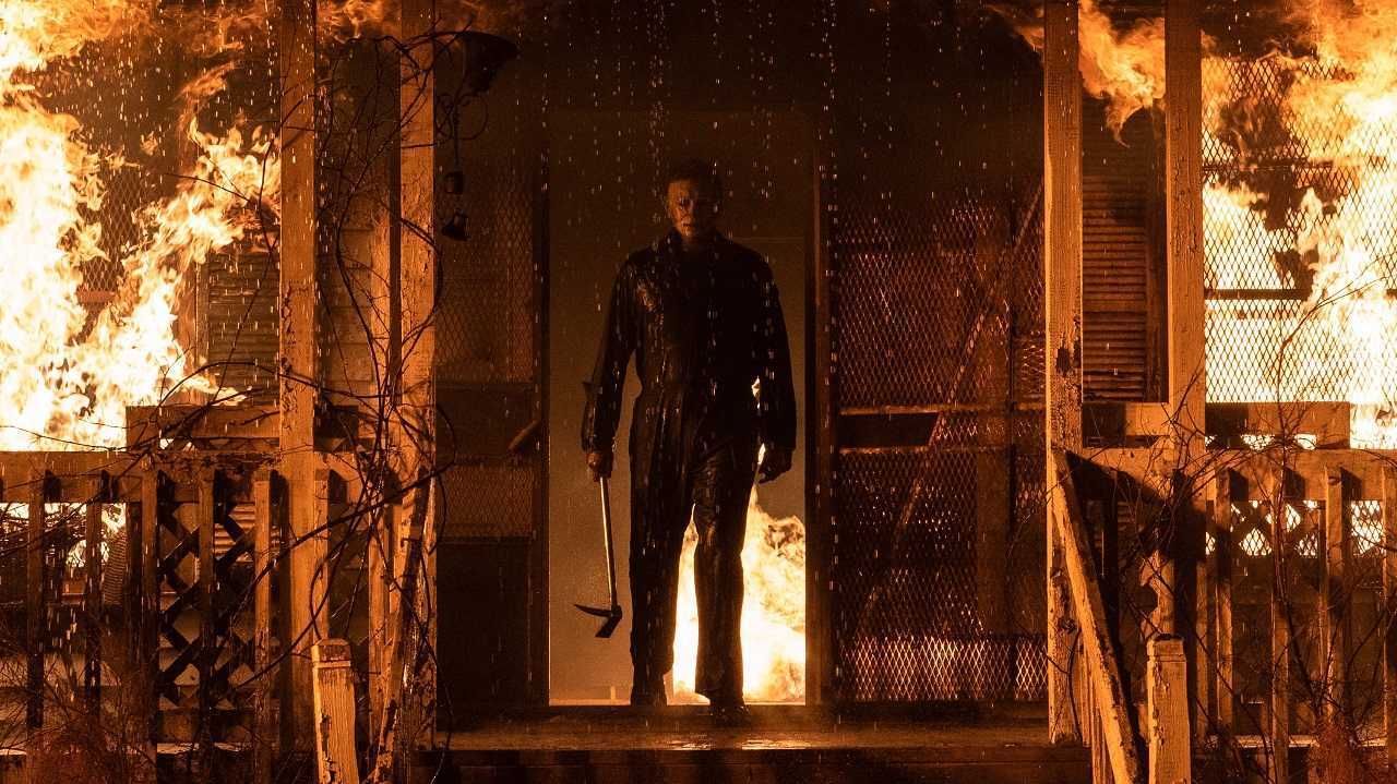 Michael Myers (James Jude Courtney) emerges from the burning ruin of Jamie Lee Curtis's house in Halloween Kills (2021)